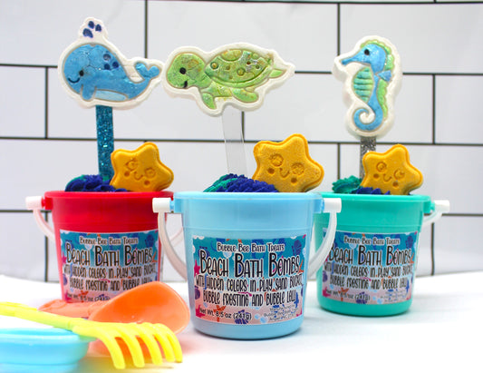 Summer beach bath bomb with bubble frosting and bubble lollipop in mini plastic bucket with sand toys
